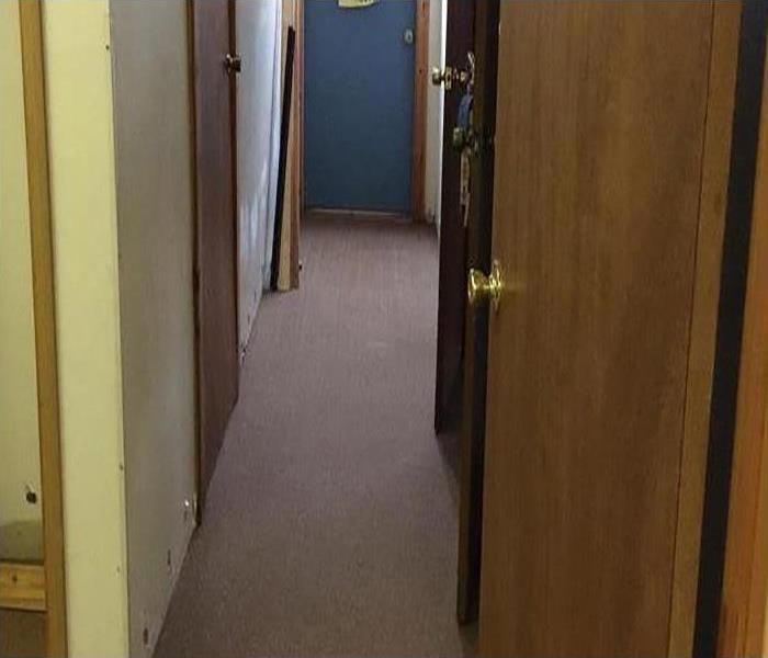hallway with brown carpet