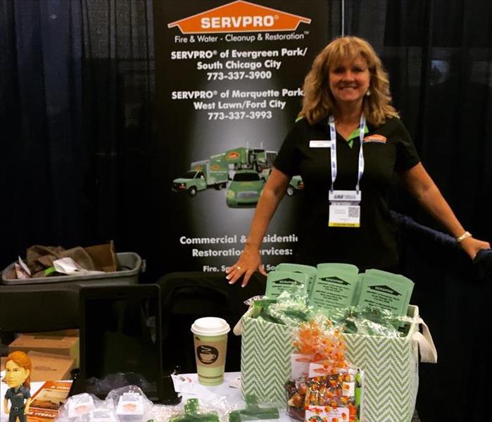 female employee at a desk with SERVPRO promotional items