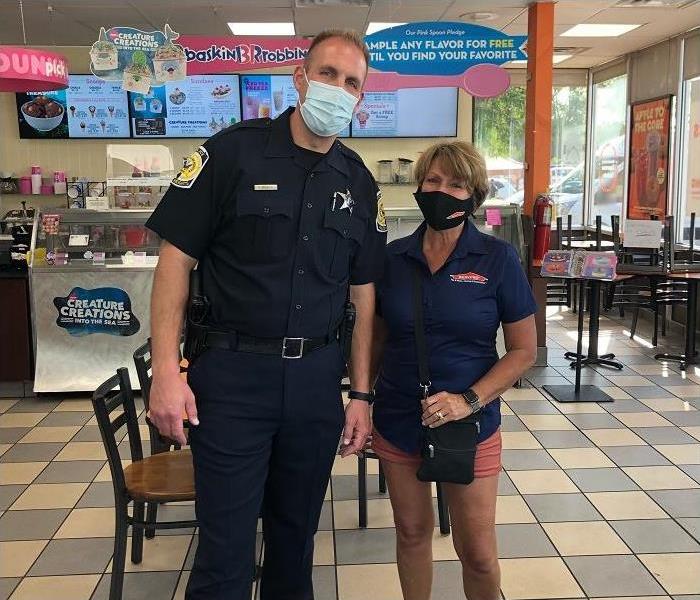 Woman and police officer inside Baskin Robbins