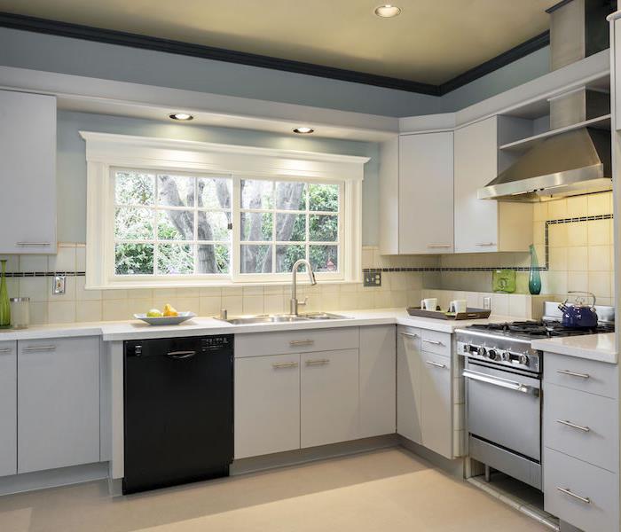 kitchen with white cabinets and a tan floor