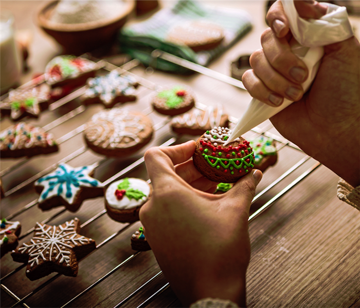 a person decorating cookies