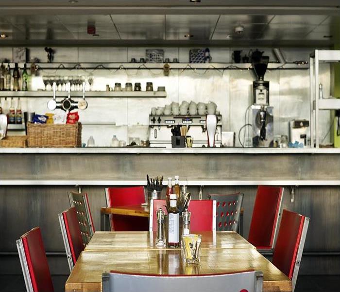 diner with a long bar and table with red chairs