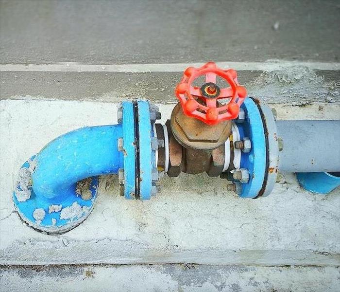 blue pipe with a red turn off valve