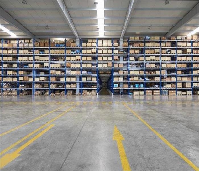 Inside warehouse; inventory stacked on shelves