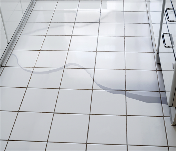 a puddle of water on tile floor